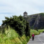 Solo cyclist going towards Mussenden Temple Causeway Coast bike tour with Ireland by Bike cycling tours